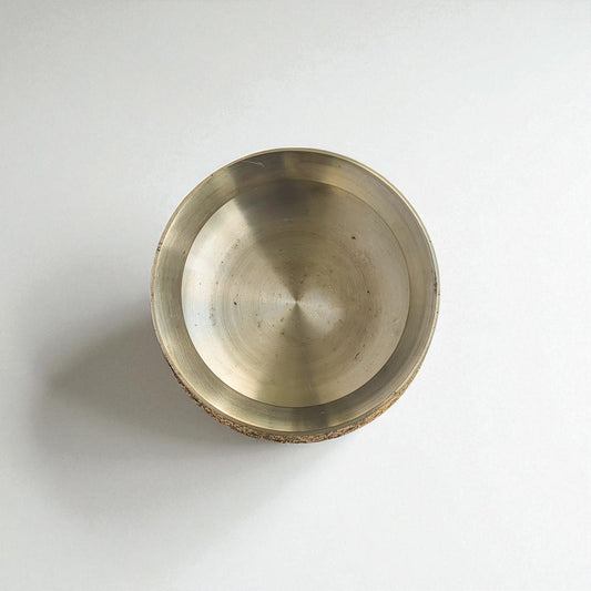 Overhead shot of the polished interior of a brass handi, showcasing its smooth finish.
