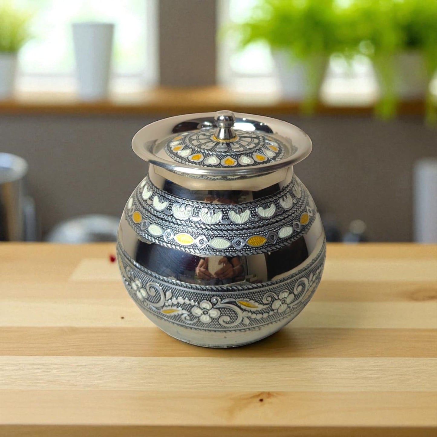 Antique Stainless Steel Lota with intricate floral and geometric designs on a wooden surface