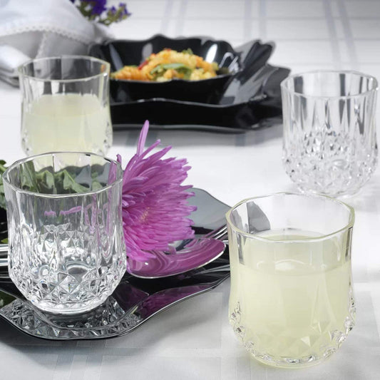 Cristal D'Arques Longchamp old fashioned 320ml glasses set on a black platter with drinks and floral decor