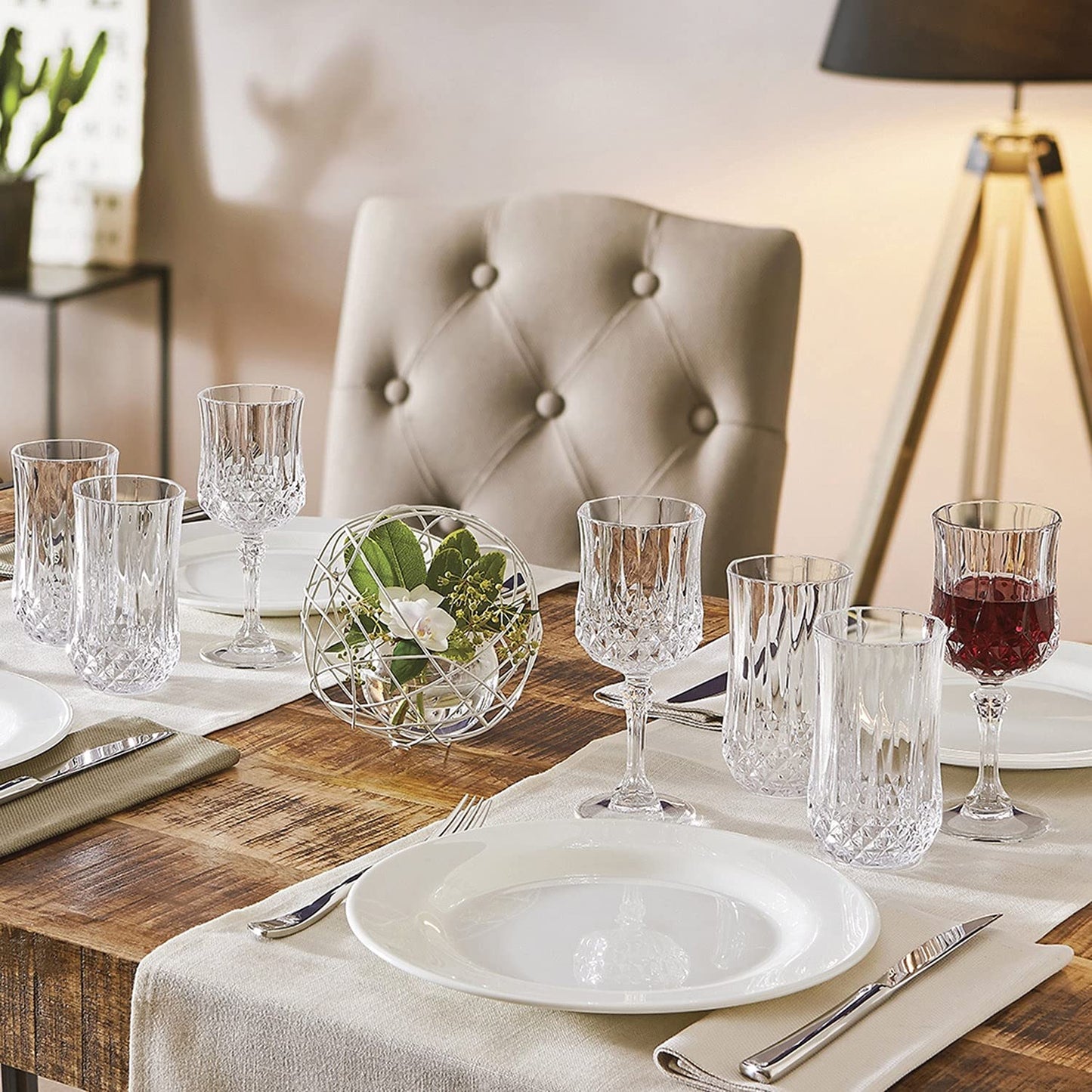 Elegant dining setup with Cristal D'Arques Longchamp Series cocktail glasses showcasing intricate designs