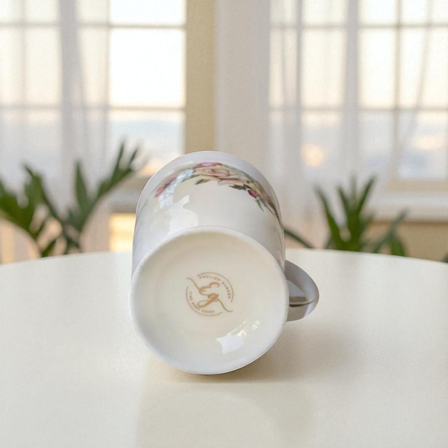 English Garden Milk Mug Rose Noir with floral design shown from the bottom on a white table