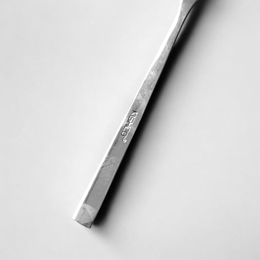 Close-up of polished handle of Kishco Cutlery Olympus Serving Spoon oval with engraved brand name