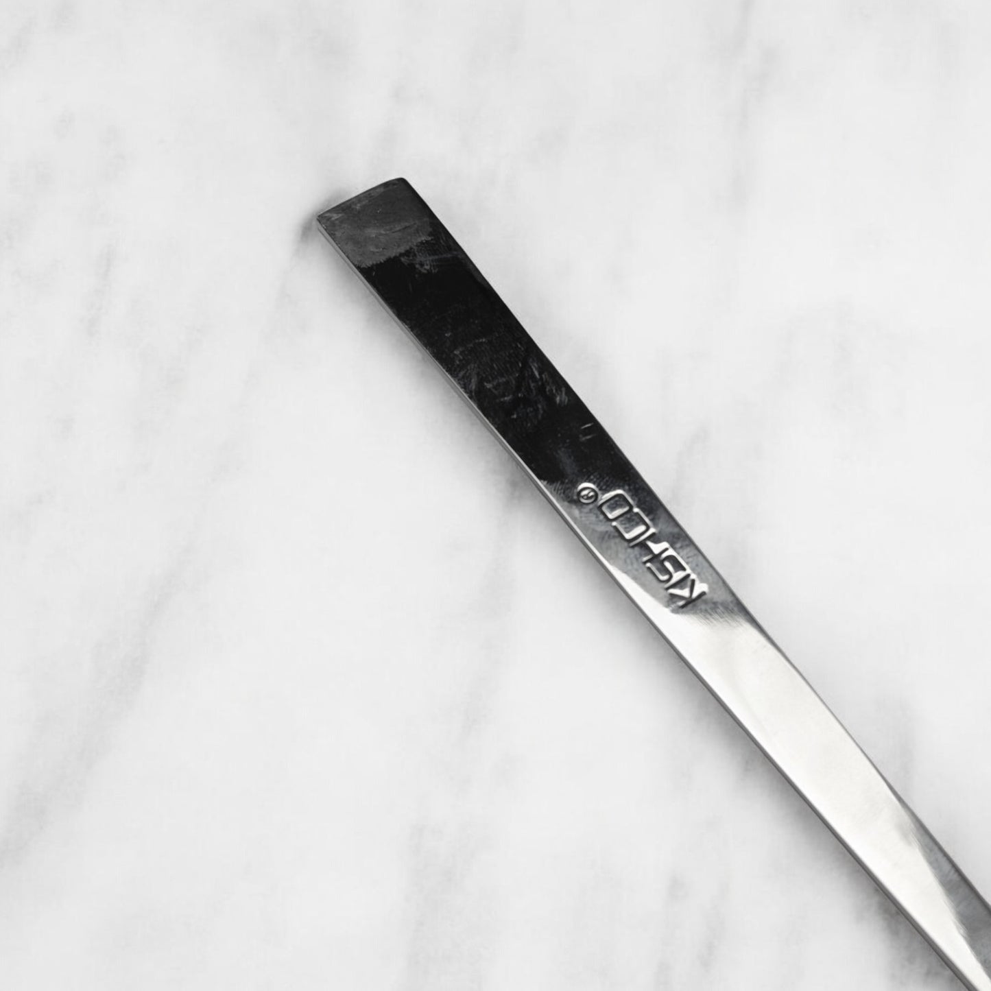 Kishco cutlery Olympus Serving Spoon Square stainless steel handle on marble surface