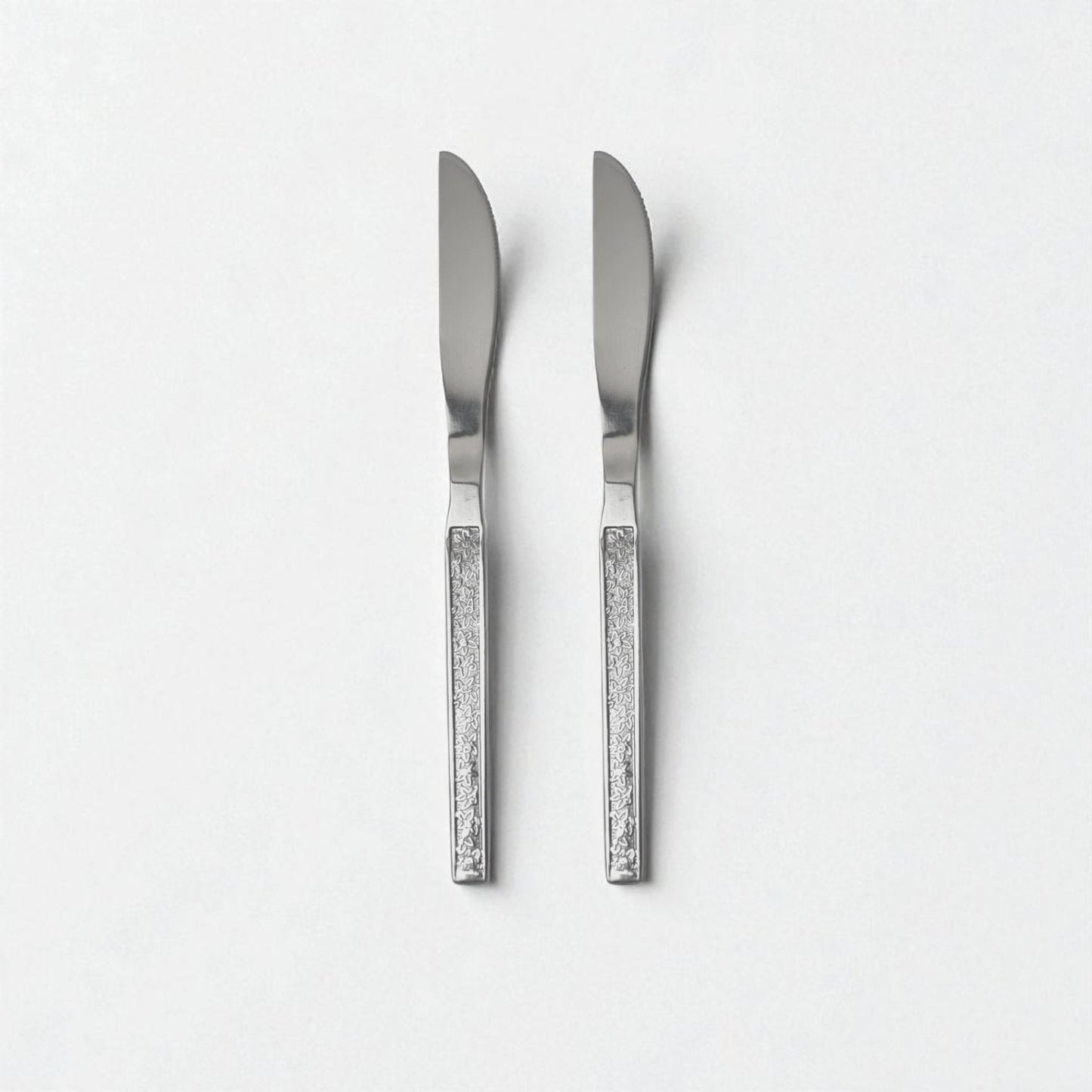 Two Kishco cutlery Parma Dinner Knife with textured handles and stainless steel blades on a white background