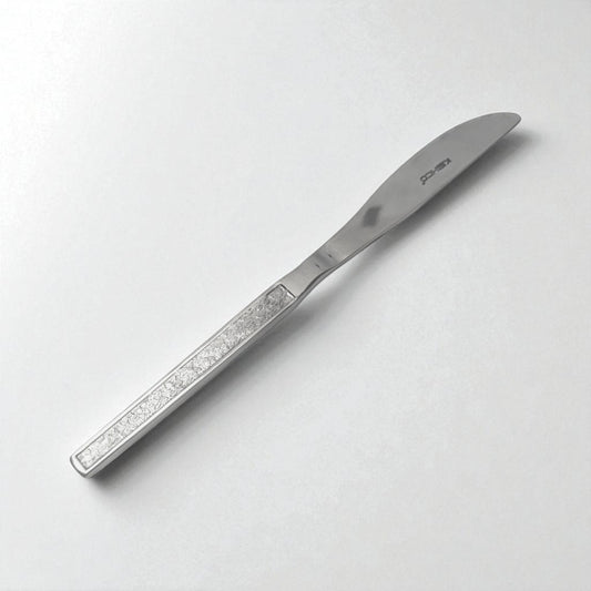 Kishco cutlery Parma Dinner Knife with a stainless steel textured handle on a white background
