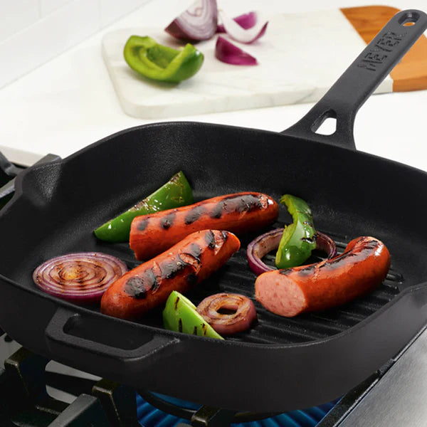 Meyer Cast Iron Grill Pan cooking grilled sausages green peppers and red onions on stove