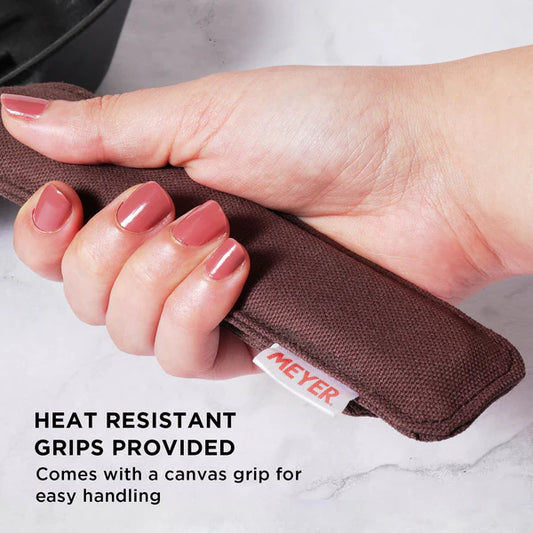 Hand holding heat resistant canvas grip for Meyer Cast Iron Grill Pan for safe handling