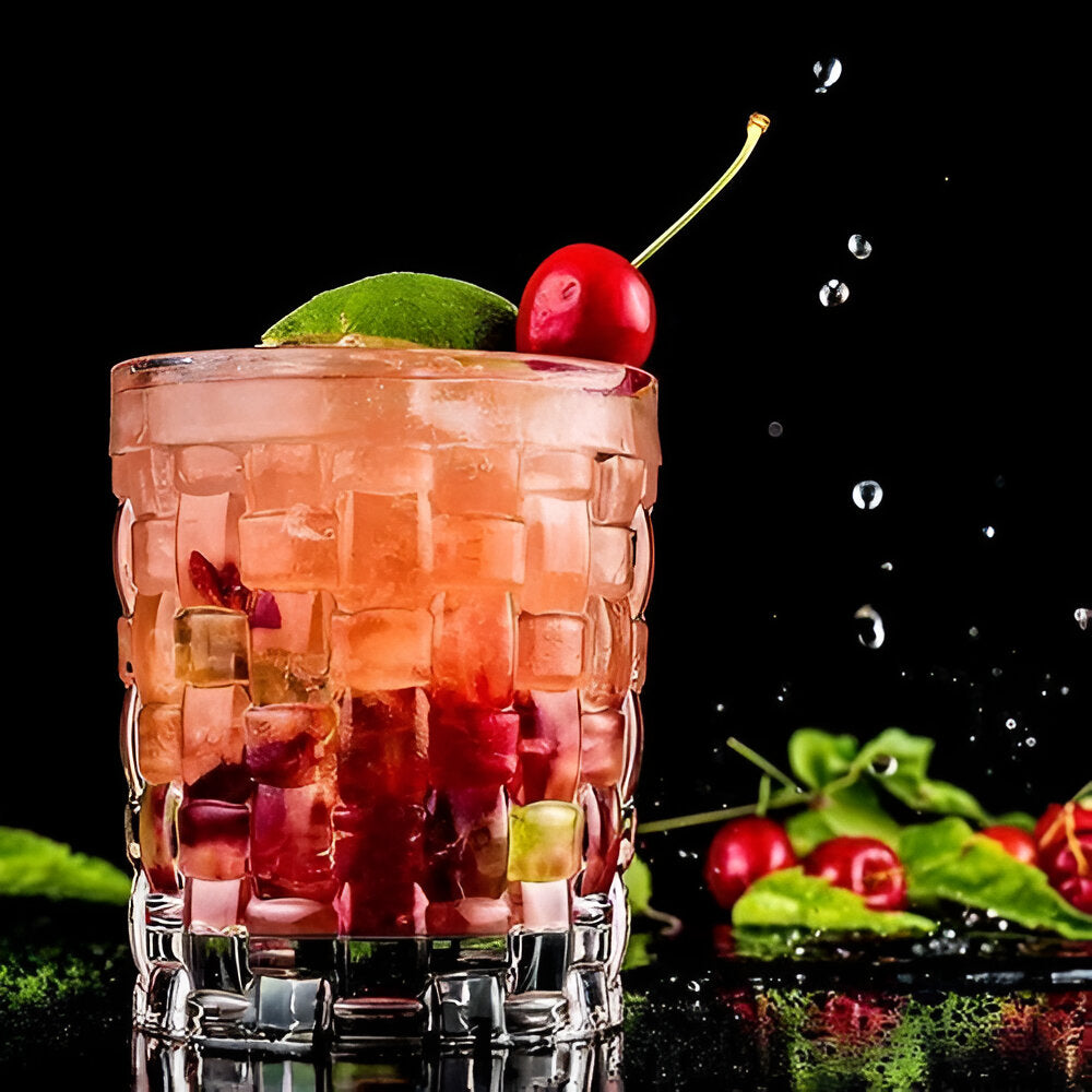 Nachtmann Bossa Nova whiskey glasses showcasing a refreshing cocktail with cherry and lime garnish