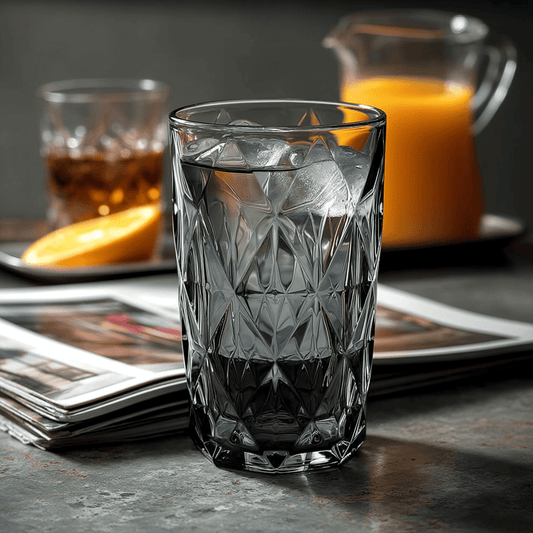 Prisma Colored Glasses Set of 6 Grey 500ml multi-use glass filled with ice on table with juice and drink in background