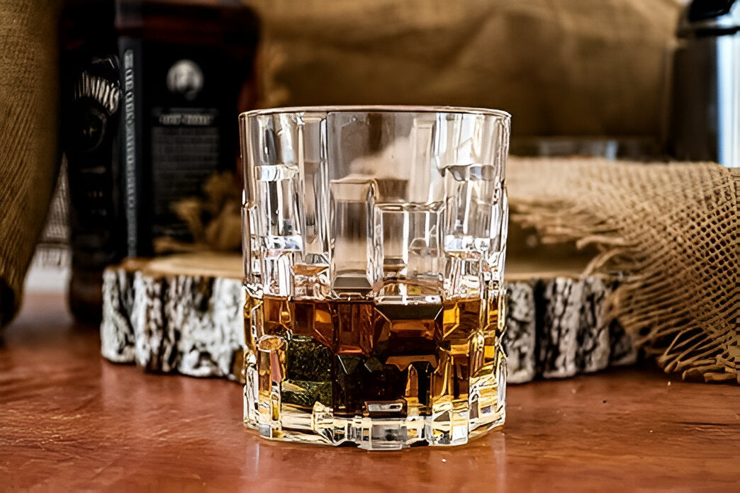 RCR Etna DOF Whiskey Glasses featuring a textured design and filled with whiskey on a wooden surface