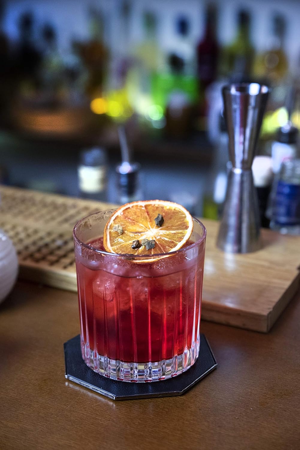 RCR Timeless whiskey glasses featuring a refreshing cocktail with a dried orange garnish