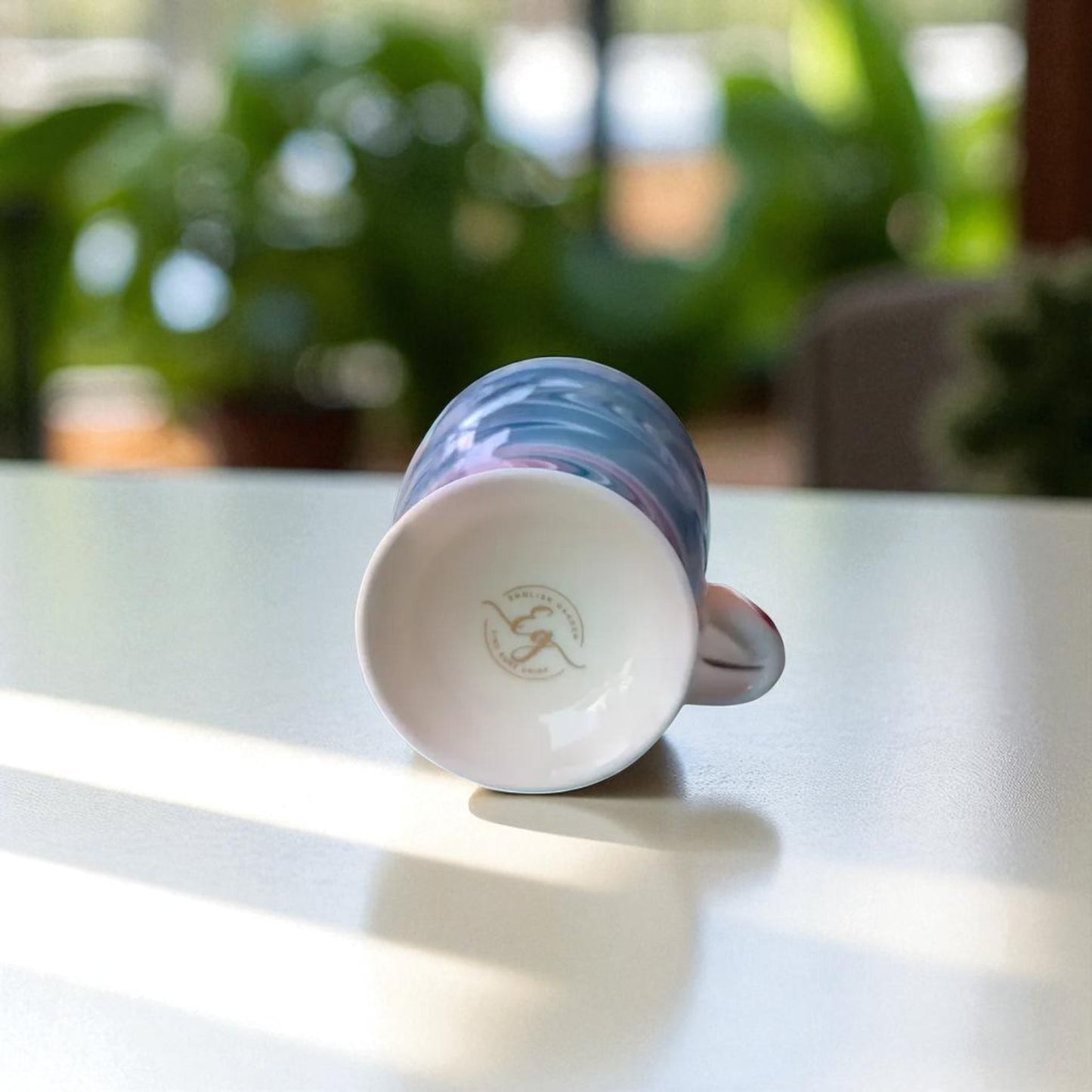 English Garden Milk Mug Royal Vortex with blue swirl design lying on its side on white surface