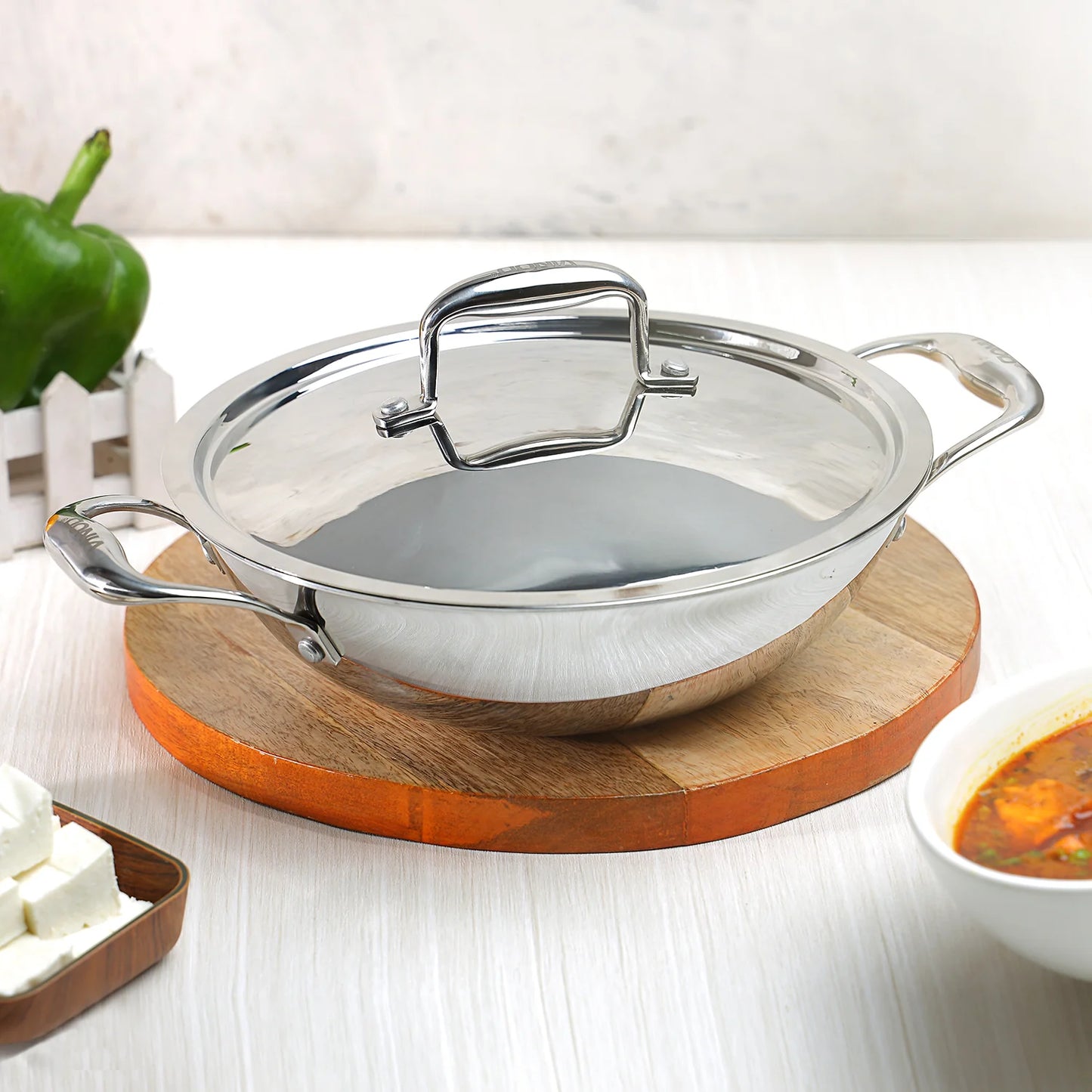 Vinod Platinum Triply Kadhai SS Lid 28cm 3.7L on a wooden base, ideal for cooking and serving