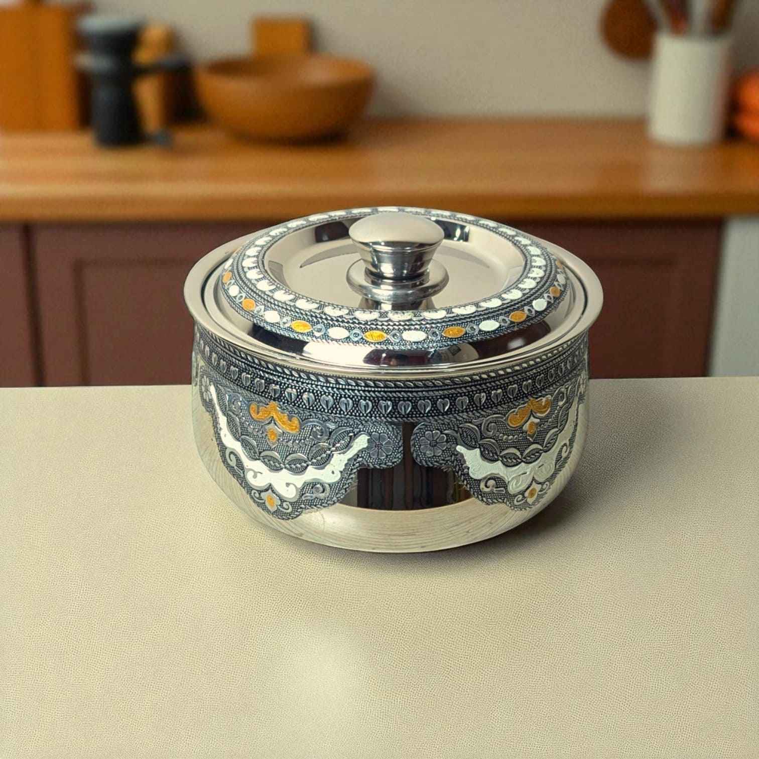 Mirror Antique Stainless Steel Casserole 2.2 litre with decorative engraved design and lid on kitchen counter