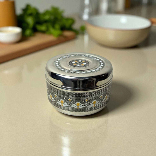 Mirror Antique Stainless Steel Half Dabba 1.5L with decorative floral design on kitchen counter