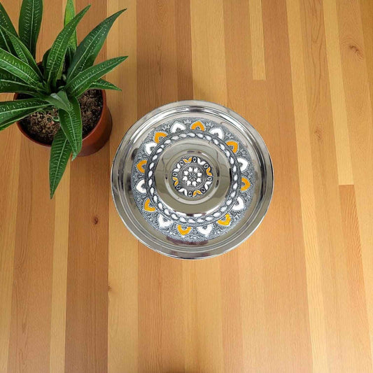 Antique Stainless Steel Pawali 9 litre from Mirror with intricate design on wooden surface next to green plant