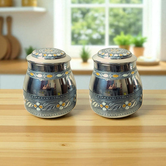 Mirror branded Antique Tea and Sugar Canisters with intricate floral patterns on a wooden countertop