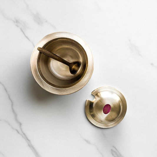 Bronze kansa loti oil spoon lid set for Pooja by Kansyam with traditional design on marble surface