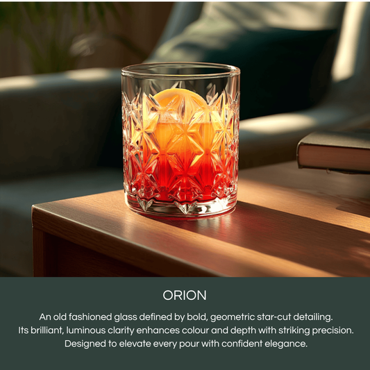 Celestial Orion Premium Whiskey glasses showcasing a bold star-cut design with a citrus garnish