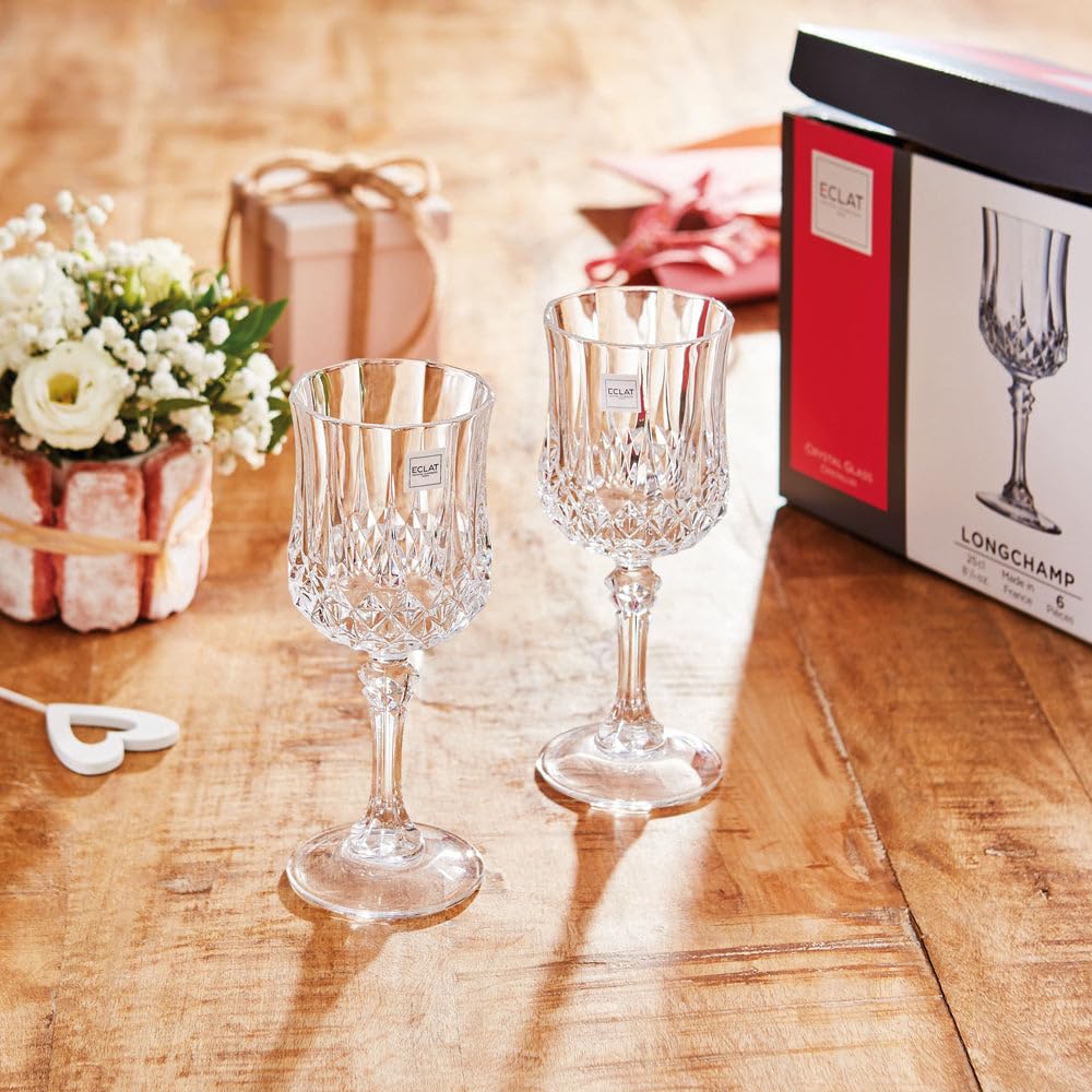 Cristal D'Arques Longchamp Wine Glass 250ml set displayed on a wooden table with festive wrapping and flowers