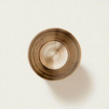Kansa damru glass bronze showing a smooth, elegant interior and polished finish for a unique decor piece