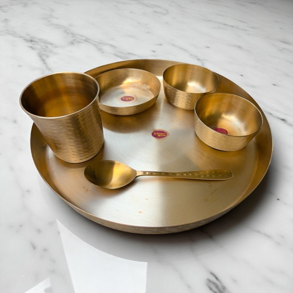 kansyam kansa dinnner set and thali of hammerred finish on a white marble