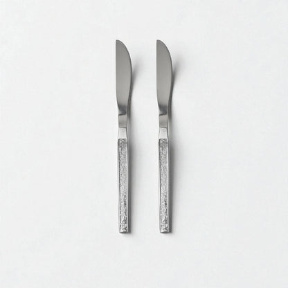Two Kishco cutlery Parma Dinner Knife with textured handles and stainless steel blades on a white background