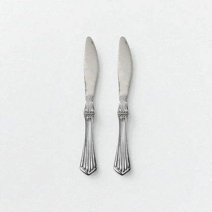 Two Kishco Cutlery Symphony Dinner Knives with ornate silver handles and polished blades