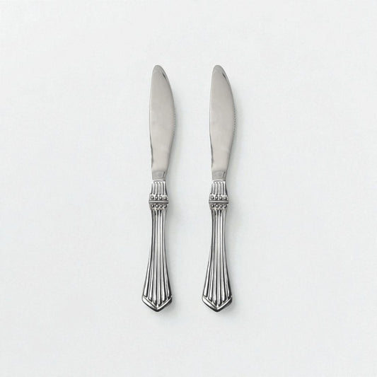 Two Kishco Cutlery Symphony Dinner Knives with ornate silver handles and polished blades
