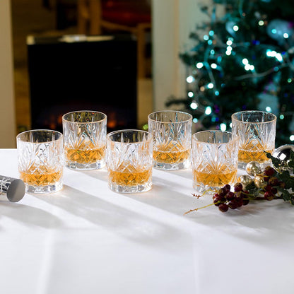 RCR Melodia DOF whiskey glasses with whiskey, styled in a festive lifestyle setting.