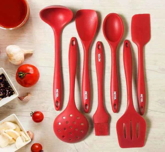 Meyer Silicone Brush Red and matching red kitchen utensils set on a wooden surface with fresh ingredients