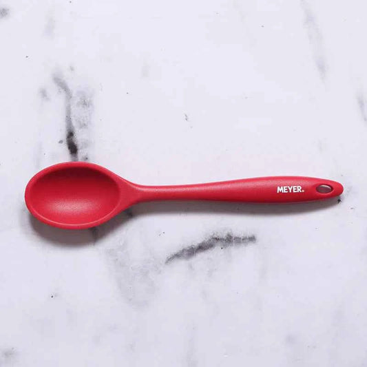 Meyer Silicone Spoon Red durable serving spoon with ergonomic handle on white marble surface