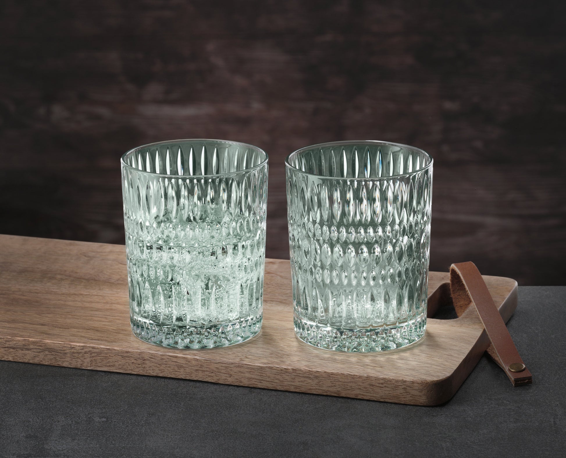Nachtmann Ethno whiskey glasses set on a wooden serving tray, showcasing elegant textured design