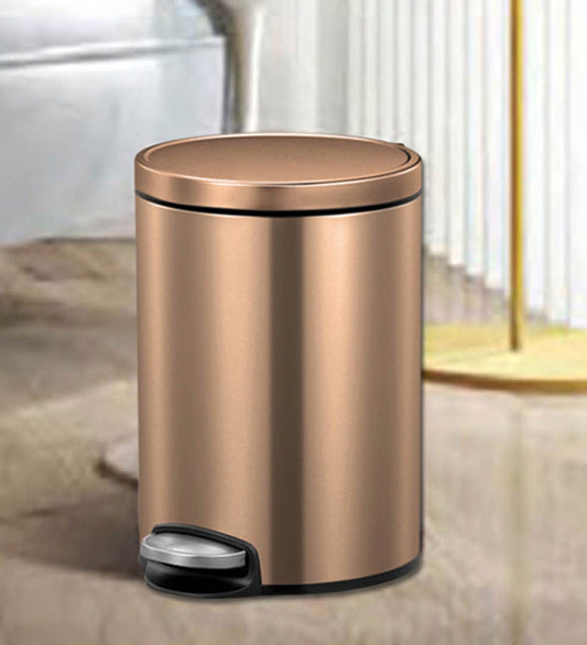 Obsessions Artistic Stainless Steel Dustbin 5 Ltr Bronze Copper with foot pedal in a compact room setting