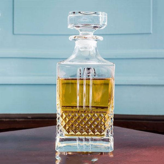 Elegant RCR Brillante whiskey decanter showcasing intricate design with whiskey inside on a polished wooden surface
