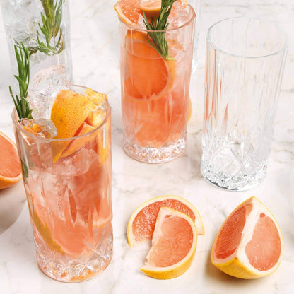 RCR Opera Cocktail Tumbler Set featuring elegant designs filled with refreshing cocktails and garnished with citrus