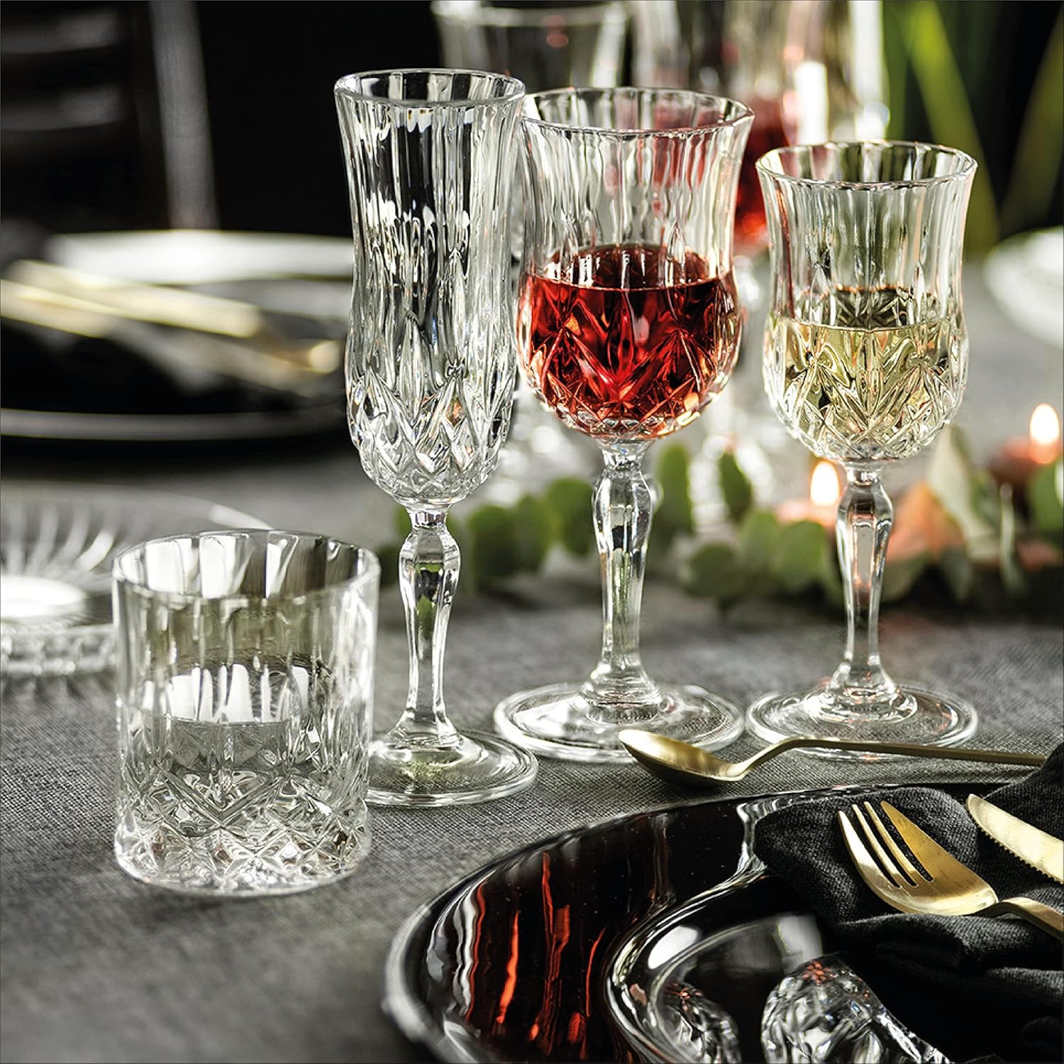 RCR Opera Flute Goblet and wine glasses on an elegant dinner table setting with candles and cutlery
