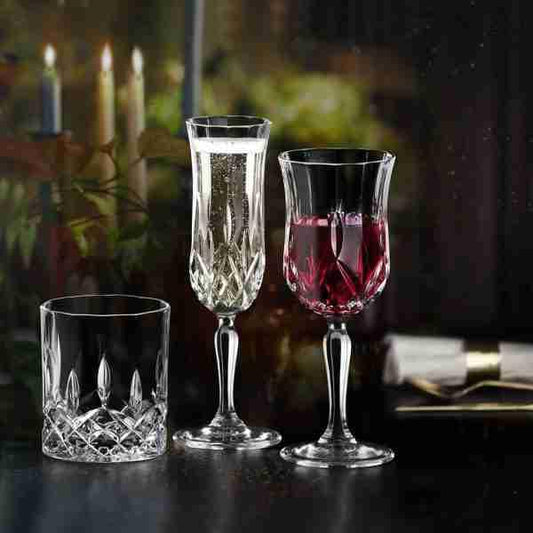 RCR Opera Red Wine Glasses in a sophisticated, dimly lit setting with candles. Perfect for evening entertaining