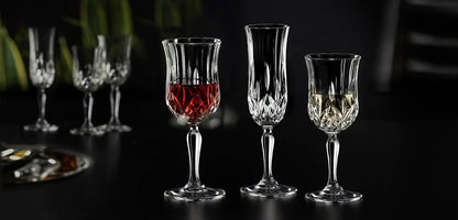 RCR Opera White Wine Glasses set on a dark background, highlighting their brilliant crystal and design details