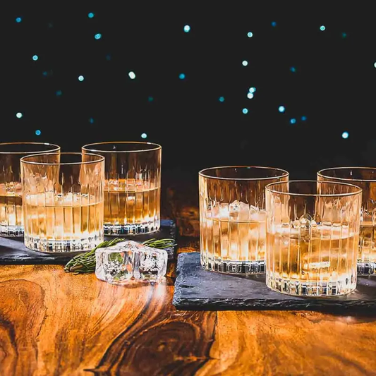 RCR Timeless crystal premium whiskey glasses elegantly showcasing fine whiskey on a wooden surface