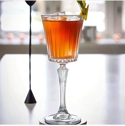 Elegant RCR Timeless Red Wine Glasses showcasing a beautifully crafted cocktail with ice and garnish