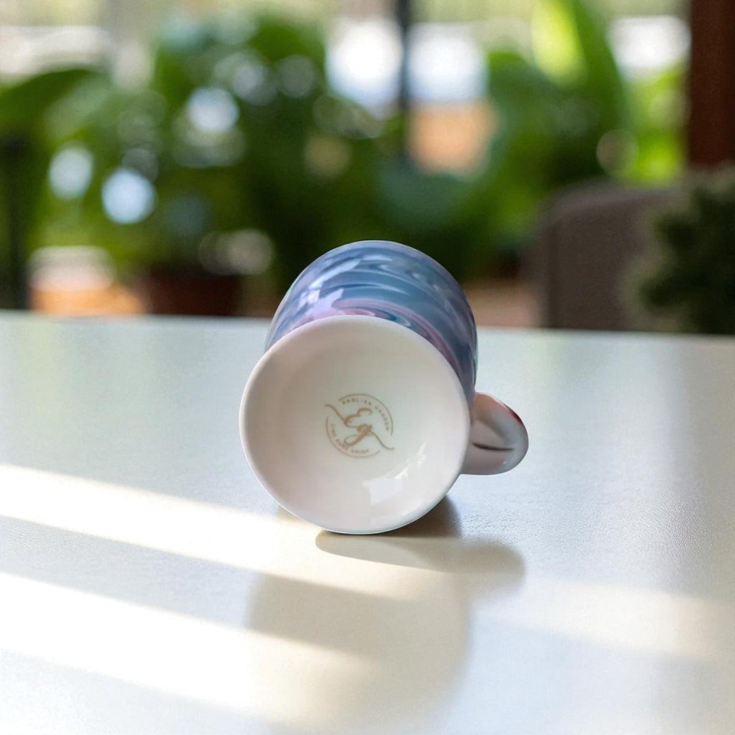 English Garden Milk Mug Royal Vortex with blue swirl design lying on its side on white surface